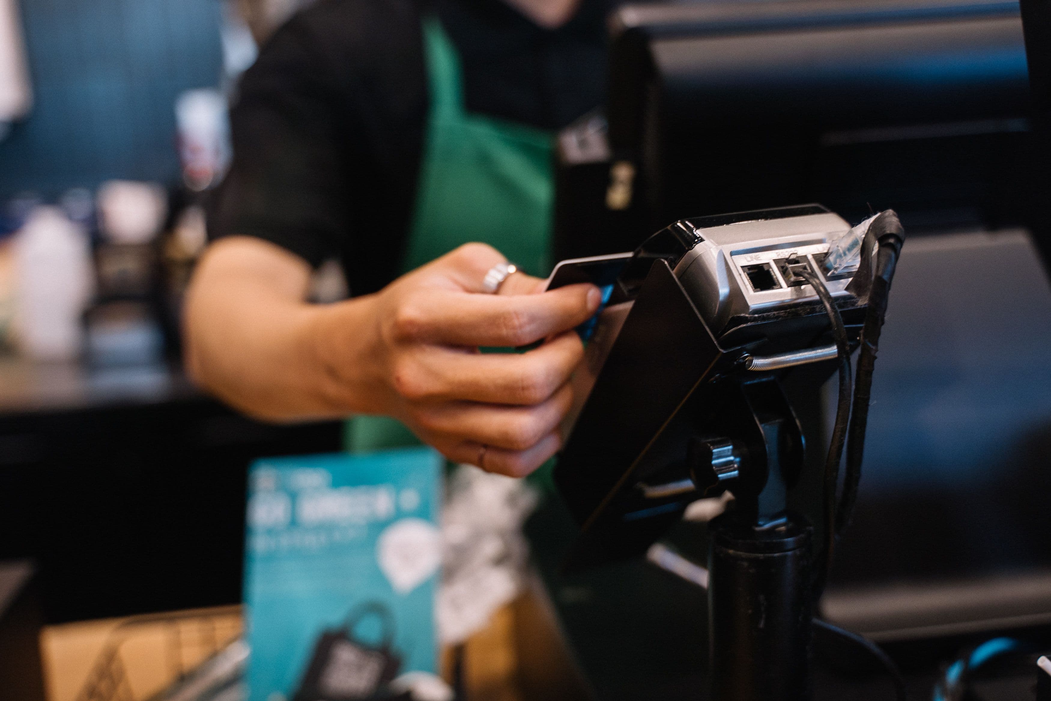 A business owner taking a card payment at the till